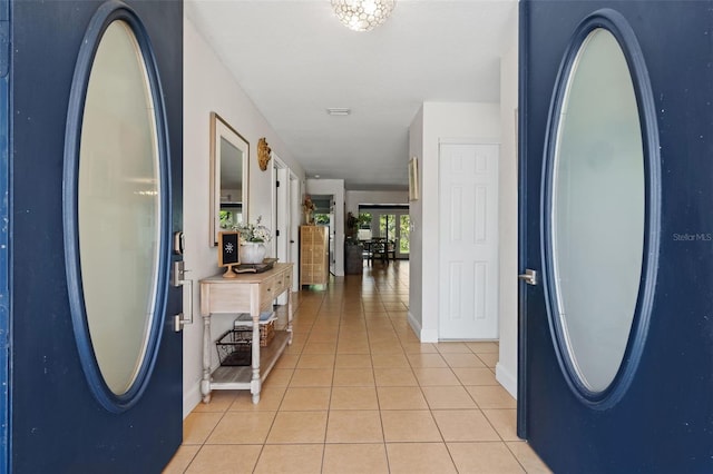 foyer with light tile patterned floors and baseboards