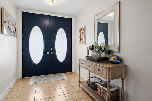 entryway with light tile patterned floors, french doors, and baseboards