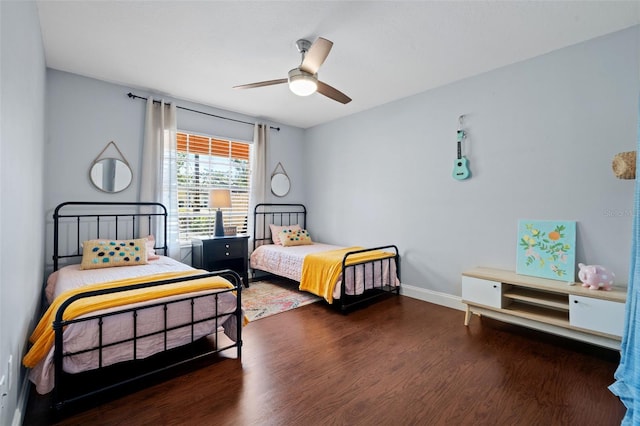 bedroom with ceiling fan, baseboards, and wood finished floors