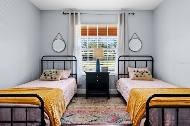 bedroom with baseboards and wood finished floors