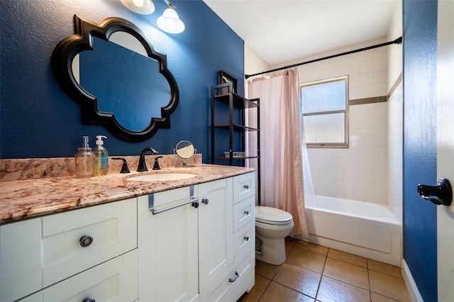 full bath with tile patterned floors, shower / bath combo with shower curtain, toilet, vanity, and a textured wall