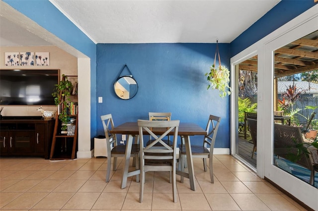 dining room featuring baseboards and tile patterned flooring