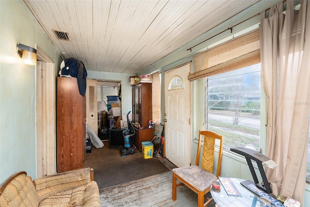 interior space featuring wooden ceiling, wood finished floors, and visible vents