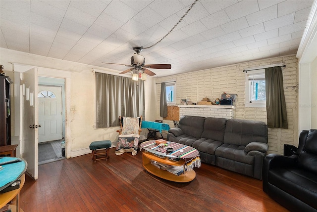 living area with a ceiling fan and hardwood / wood-style flooring