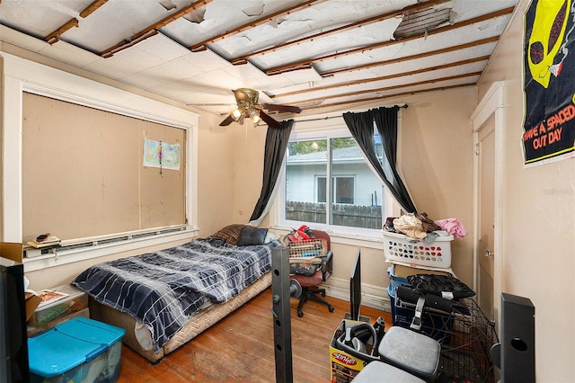 bedroom with wood finished floors and baseboards