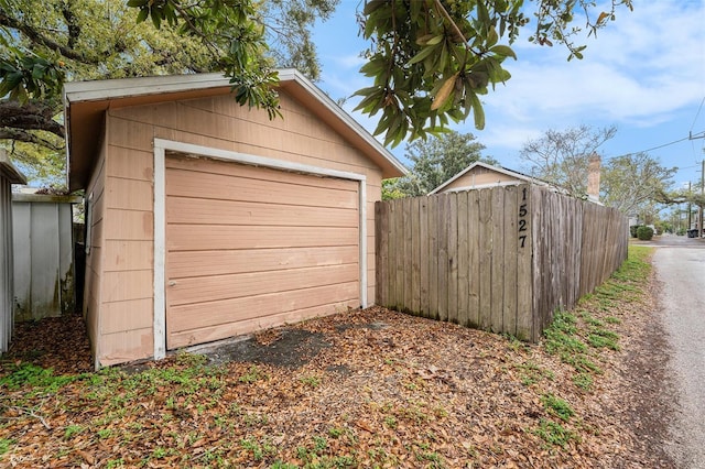 detached garage with driveway and fence