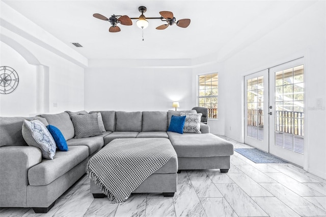 living room with ceiling fan, marble finish floor, french doors, and visible vents