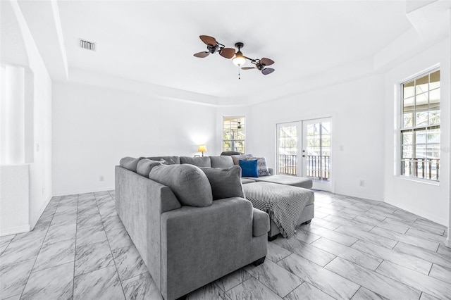 living room with visible vents, baseboards, ceiling fan, marble finish floor, and french doors