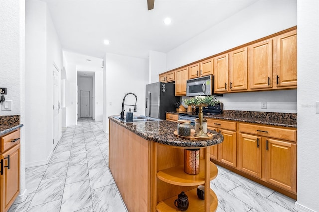 kitchen with appliances with stainless steel finishes, marble finish floor, a kitchen island with sink, open shelves, and a sink