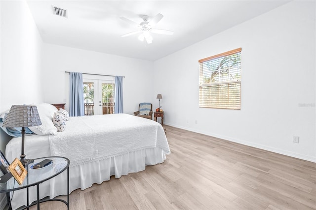 bedroom with light wood finished floors, visible vents, baseboards, access to outside, and french doors