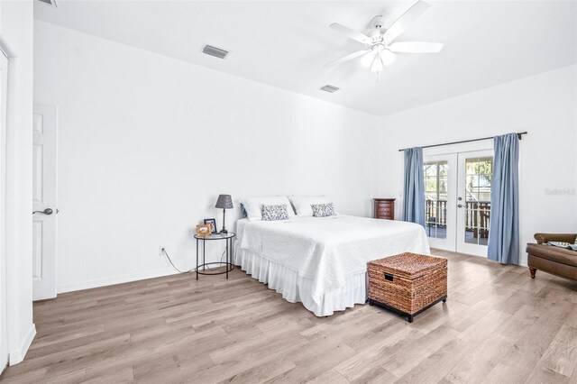 bedroom featuring access to exterior, light wood-type flooring, french doors, and visible vents