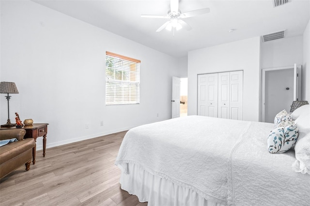 bedroom featuring baseboards, visible vents, a ceiling fan, light wood-type flooring, and a closet