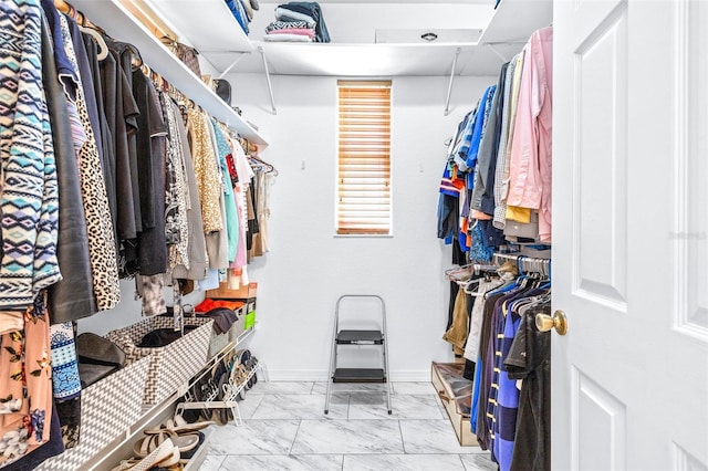 spacious closet with marble finish floor