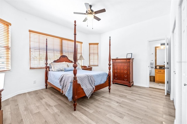 bedroom featuring light wood-style flooring, baseboards, a ceiling fan, and ensuite bathroom