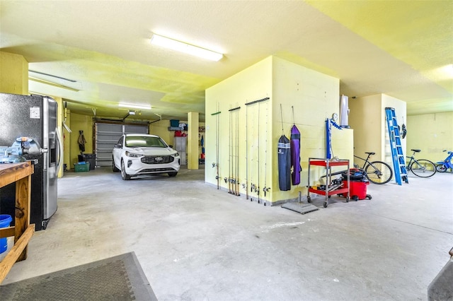 garage with stainless steel fridge