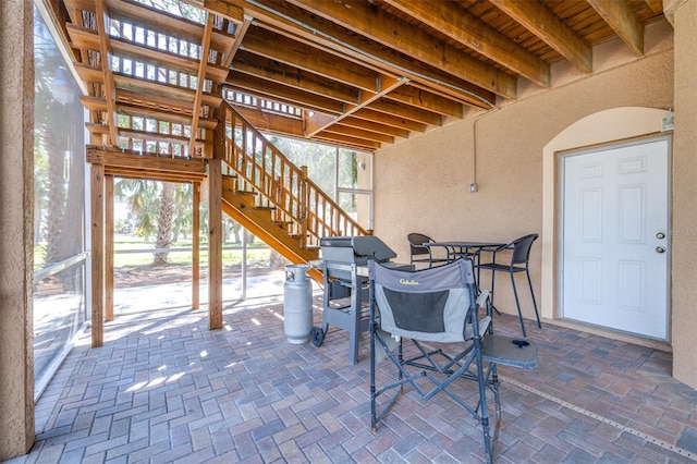 view of patio with stairs and outdoor dining space