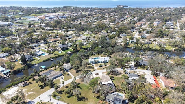 drone / aerial view with a water view and a residential view