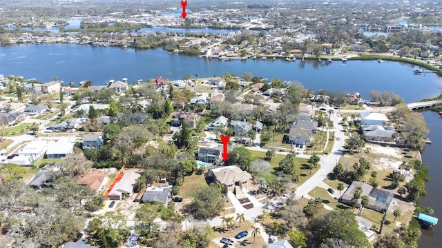 birds eye view of property with a residential view and a water view