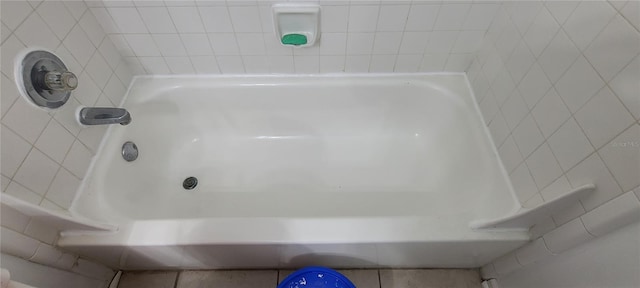 bathroom featuring a bathing tub and tile walls