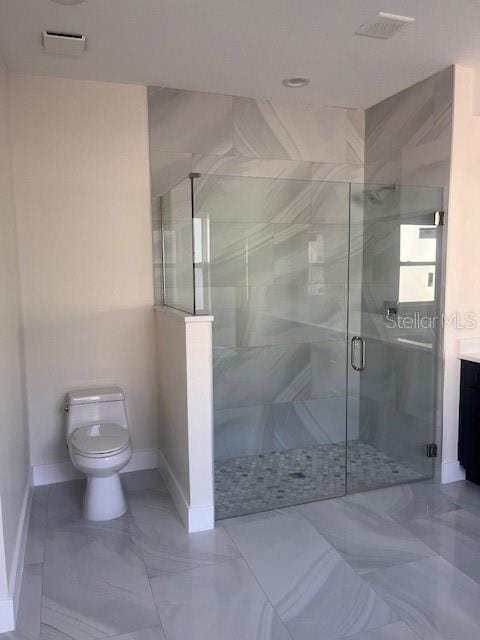 bathroom with toilet, vanity, baseboards, marble finish floor, and a stall shower