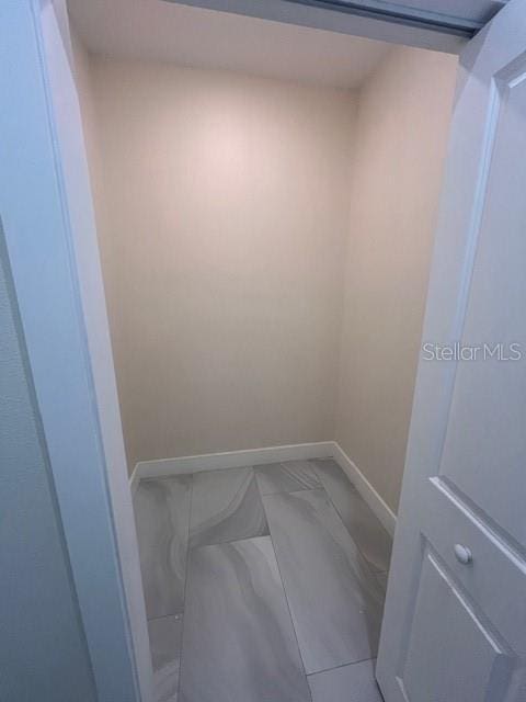 spare room with baseboards