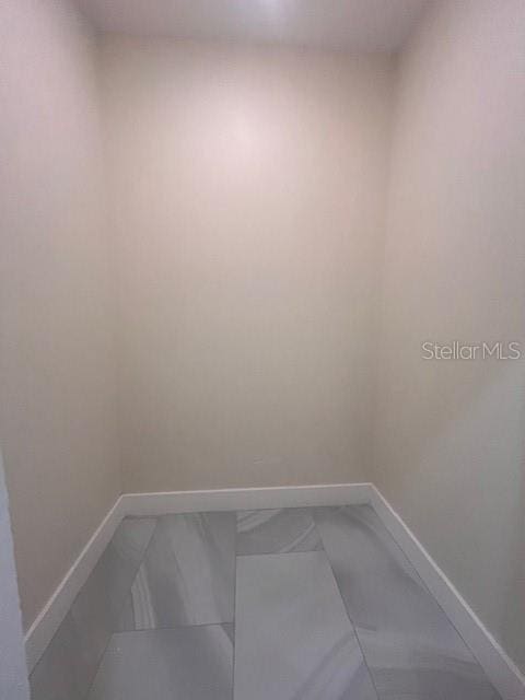 unfurnished room featuring baseboards