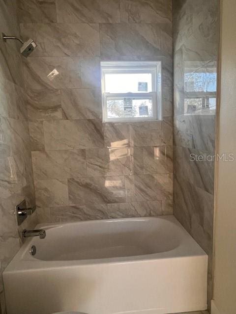 bathroom featuring washtub / shower combination