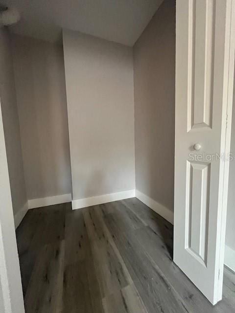 empty room with wood finished floors and baseboards