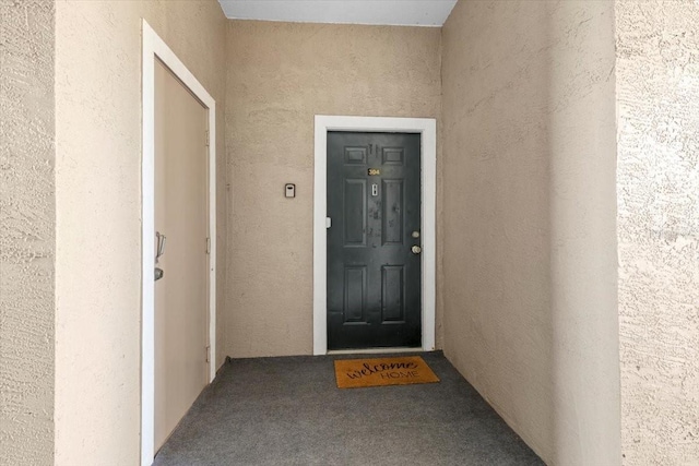 doorway to property with stucco siding