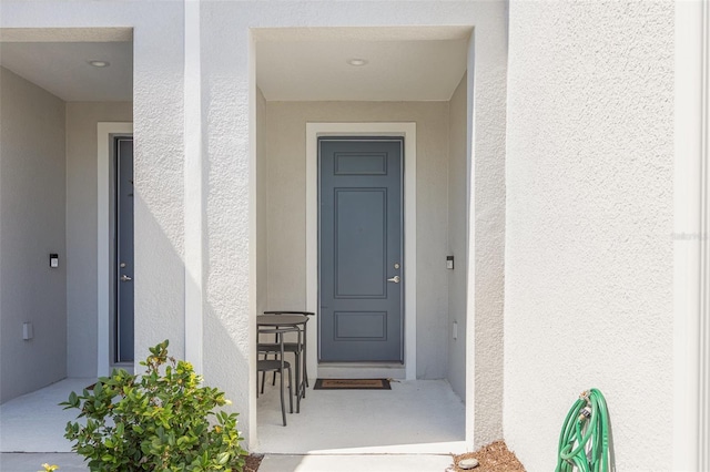 entrance to property with stucco siding