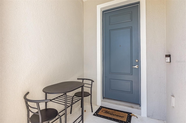 property entrance with stucco siding