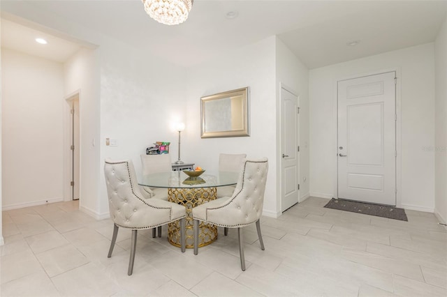 dining room featuring recessed lighting, an inviting chandelier, and baseboards