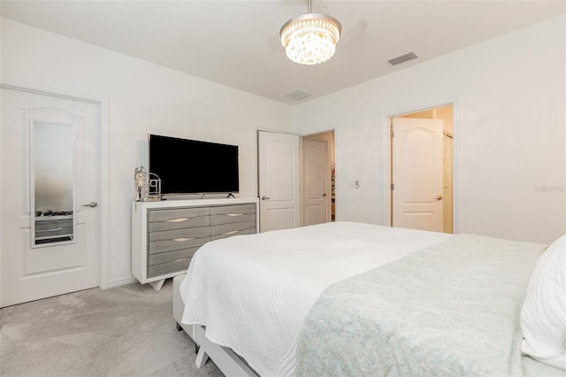 bedroom with light carpet, visible vents, and a chandelier