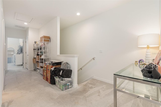 corridor with carpet floors, visible vents, attic access, an upstairs landing, and baseboards