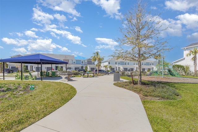 view of home's community with a gazebo, a residential view, playground community, and a yard