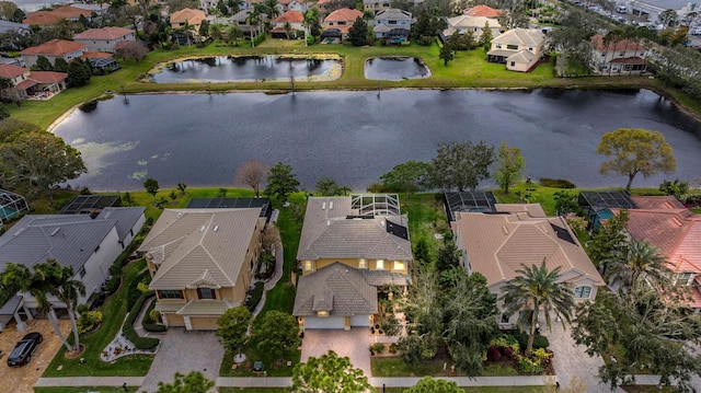 birds eye view of property with a water view and a residential view