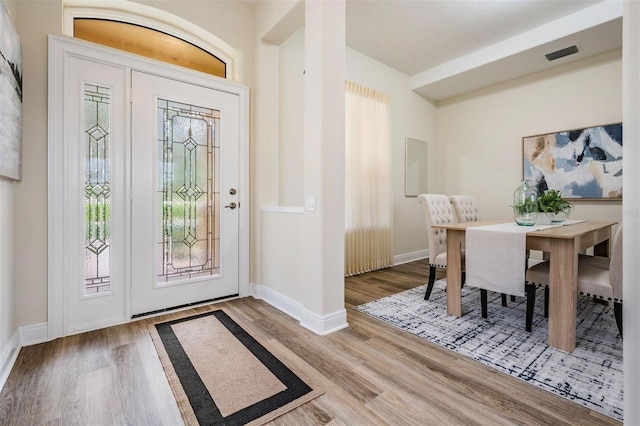 2665 Lakebreeze Ln N, Clearwater, FL 33759 - entrance foyer featuring healthy amount of natural light and wood finished floors