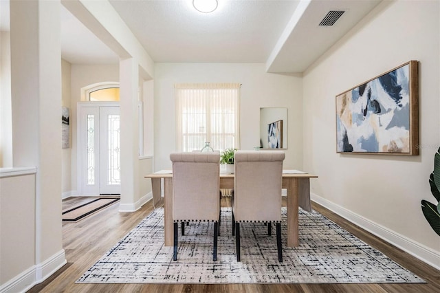 2665 Lakebreeze Ln N, Clearwater, FL 33759 - dining room featuring wood finished floors and plenty of natural light