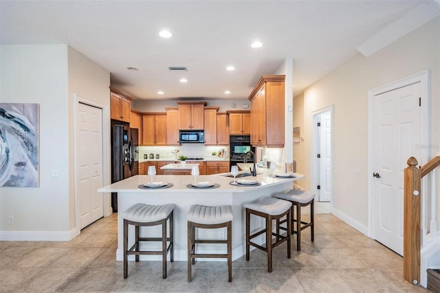 2665 Lakebreeze Ln N, Clearwater, FL 33759 - kitchen with black appliances, a kitchen breakfast bar, a peninsula, light countertops, and recessed lighting
