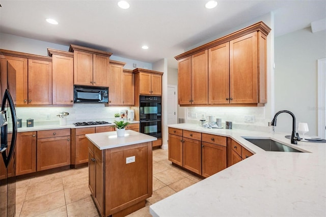 2665 Lakebreeze Ln N, Clearwater, FL 33759 - kitchen featuring black appliances, backsplash, light countertops, a kitchen island, and recessed lighting