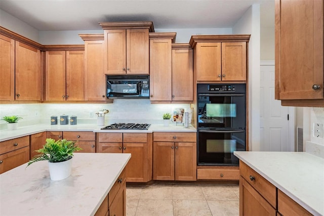 2665 Lakebreeze Ln N, Clearwater, FL 33759 - kitchen featuring black appliances, decorative backsplash, and brown cabinetry