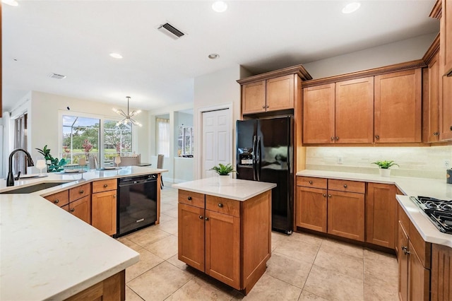 2665 Lakebreeze Ln N, Clearwater, FL 33759 - kitchen with black appliances, a kitchen island, brown cabinetry, a chandelier, and recessed lighting