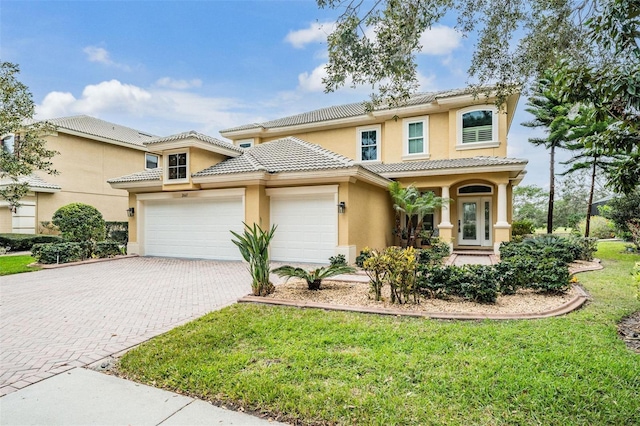 2665 Lakebreeze Ln N, Clearwater, FL 33759 - view of front facade with decorative driveway, stucco siding, an attached garage, and a tile roof
