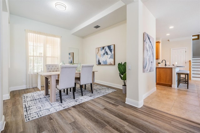 2665 Lakebreeze Ln N, Clearwater, FL 33759 - dining area featuring light wood-style floors, stairway, and recessed lighting