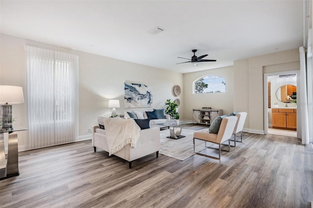 2665 Lakebreeze Ln N, Clearwater, FL 33759 - living room featuring light wood-type flooring and ceiling fan