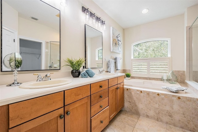 2665 Lakebreeze Ln N, Clearwater, FL 33759 - bathroom featuring double vanity, a bath, tile patterned floors, and an enclosed shower