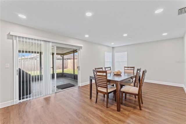 dining room with light wood-type flooring, visible vents, baseboards, and recessed lighting