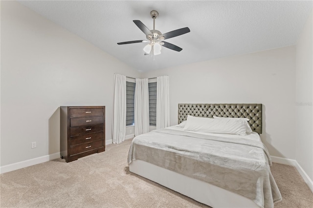 bedroom with light carpet, baseboards, lofted ceiling, ceiling fan, and a textured ceiling