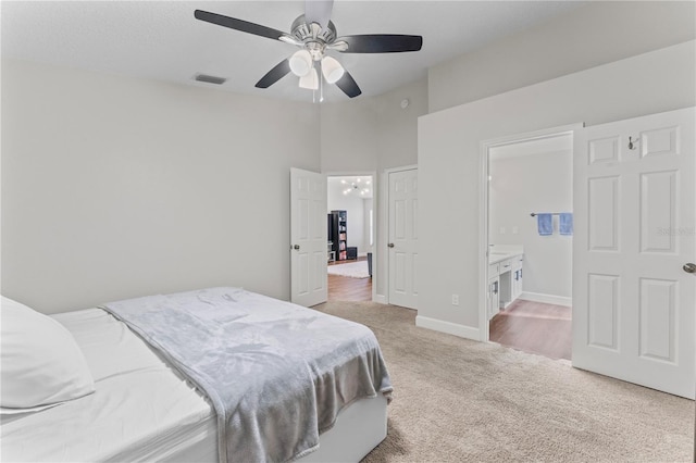 bedroom with carpet, visible vents, a ceiling fan, connected bathroom, and baseboards