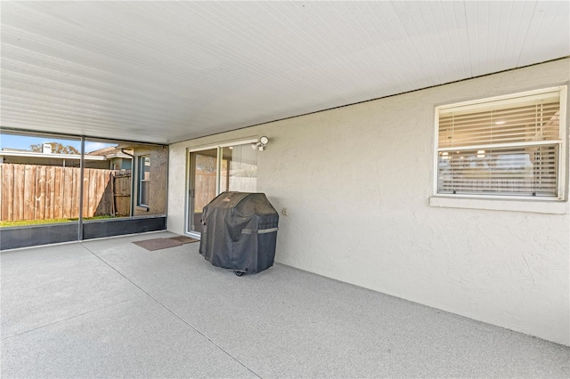 view of patio with a grill and fence